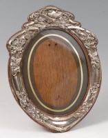 Lot 127 - An Art Nouveau floral silver embossed oval...