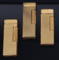 Lot 145 - Three 1950s Dunhill gilt metal engine turned...
