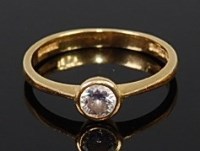 Lot 2227 - An 18ct gold diamond solitaire ring, the...