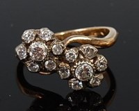 Lot 2006 - An 18ct gold diamond crossover ring arranged...
