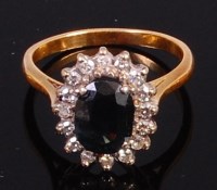 Lot 2038 - A yellow metal, sapphire and diamond flower...