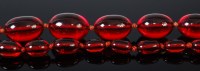 Lot 2059 - A beaded and knotted cherry amber long...