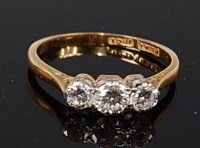 Lot 2069 - An 18ct gold and platinum set diamond three...