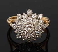 Lot 2098 - An 18ct gold and diamond flower head cluster...