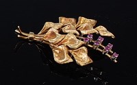 Lot 2163 - An 18ct gold ruby set brooch, as a peace-lily...