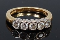 Lot 2172 - An 18ct gold diamond five stone ring, the...