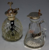 Lot 257 - An early 20th century silver topped glass...
