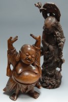 Lot 16 - A large carved hardwood figure of a smiling...