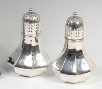 Lot 3192 - A near-pair of Edwardian silver sugar sifters,...