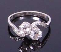 Lot 3292 - An Art Deco platinum diamond crossover ring,...