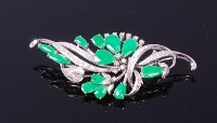 Lot 3297 - An 18ct white gold, jade and diamond set leaf...