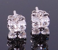 Lot 3309 - A pair of 18ct white gold diamond ear studs,...