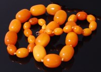 Lot 3322 - A single string of butterscotch amber barrel...