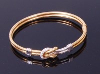 Lot 3328 - An 18ct gold diamond set hinge bangle, the...