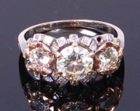 Lot 3345 - A white metal diamond three stone ring, the...