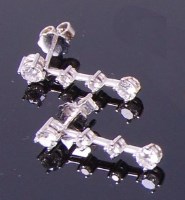 Lot 3348 - A pair of 18ct white gold and diamond drop ear...