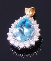Lot 3352 - An 18ct gold, aquamarine and diamond pendant,...