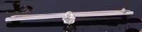 Lot 3372 - A platinum and diamond knife-edge bar brooch,...
