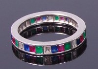 Lot 3381 - A silver precious set eternity ring, channel...