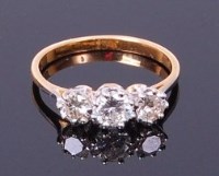 Lot 3383 - A yellow metal diamond three stone ring, as...