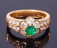 Lot 3406 - An 18ct gold, emerald and diamond flower head...
