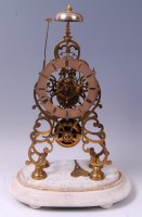 Lot 3595 - A late Victorian brass skeleton clock under...
