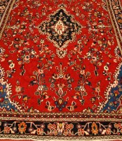 Lot 3611 - A Persian woollen carpet, the red ground...