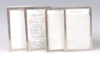 Lot 1125 - A set of three silver framed menu stands, the...