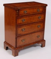 Lot 1550 - A walnut and figured walnut bachelors chest,...