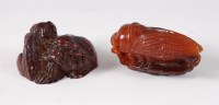 Lot 1434 - A Chinese carved amber netsuke as a cicada,...