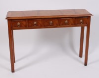 Lot 1577 - A Georgian style walnut five drawer hall table,...