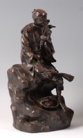 Lot 1442 - A Japanese Meiji period bronze of a seated...