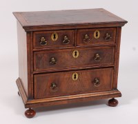 Lot 1635 - A walnut and figured walnut collectors chest,...