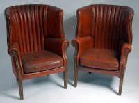 Lot 1647 - A pair of brown leather upholstered barrel...