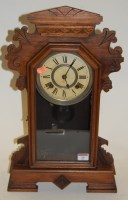 Lot 24 - A late 19th century walnut cased mantel clock,...