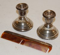 Lot 280 - A pair of silver dwarf candlesticks on loaded...