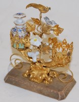 Lot 340 - A gilt metal and porcelain dressing table...
