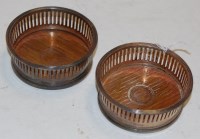 Lot 350 - A pair of small silver coasters by Asprey,...