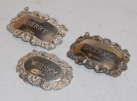 Lot 364 - A pair of silver and embossed decanter collars,...