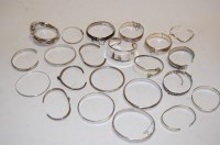 Lot 378 - A collection of silver and white metal bangles,...