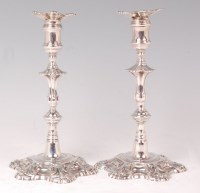 Lot 1121 - A pair of George II cast silver candlesticks,...
