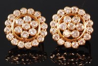 Lot 1146 - A pair of yellow metal and diamond cluster ear...