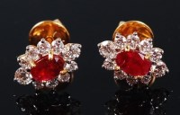 Lot 1153 - A pair of yellow metal, ruby and diamond set...