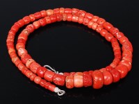 Lot 1155 - A beaded and graduated coral necklace, of...