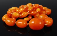 Lot 1156 - A beaded butterscotch amber single string...
