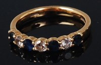 Lot 1164 - An 18ct gold, sapphire and diamond set band...