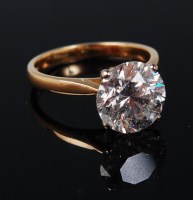 Lot 1171 - An 18ct gold diamond solitaire ring, the four...