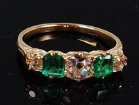Lot 1176 - A yellow metal, emerald and diamond ring, the...