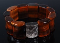 Lot 1195 - A sectional concave tigers eye expanding...