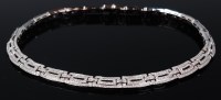 Lot 1197 - An 18ct gold and diamond set brick-link...